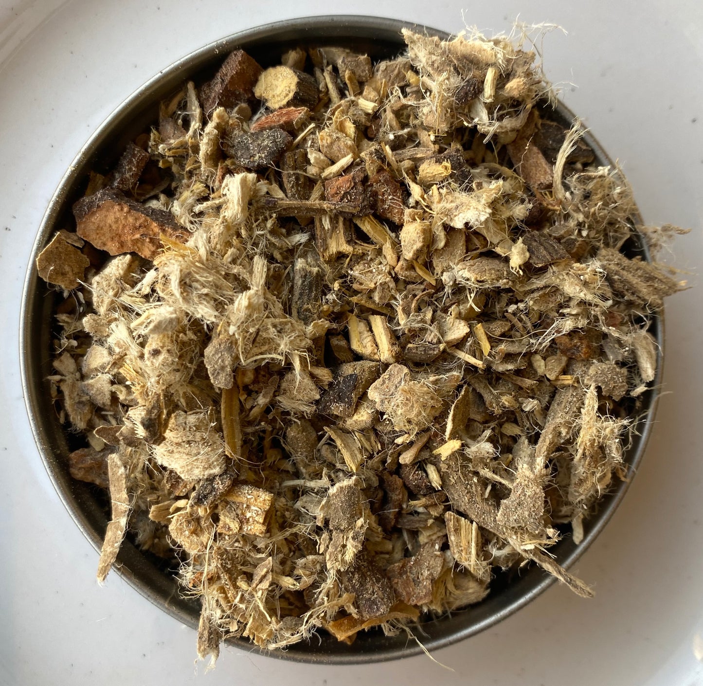 Close-up of Winter Remedy tea ingredients: ginger, cinnamon, and other natural elements for winter warmth.